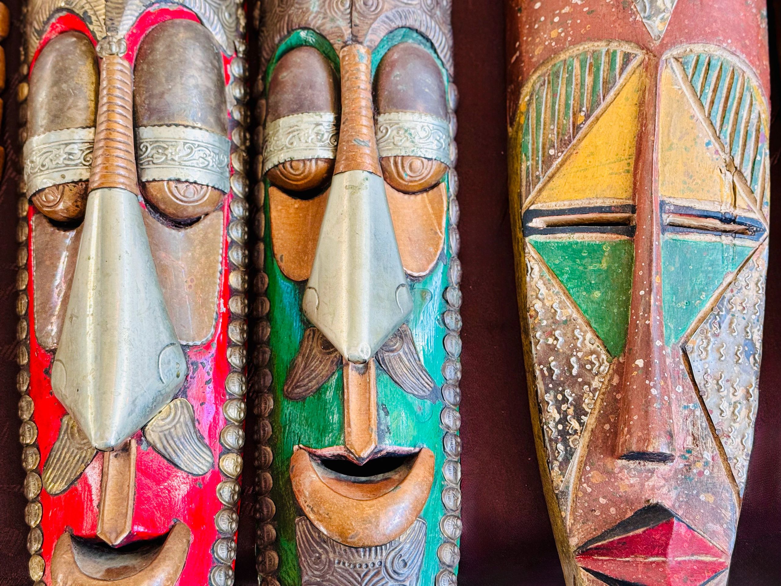 tiki culture Polynesian decor carved masks leafy greens