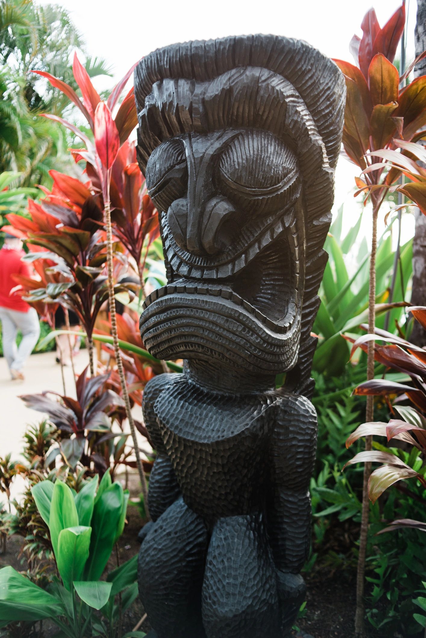 tiki culture Polynesian decor carved masks leafy greens
