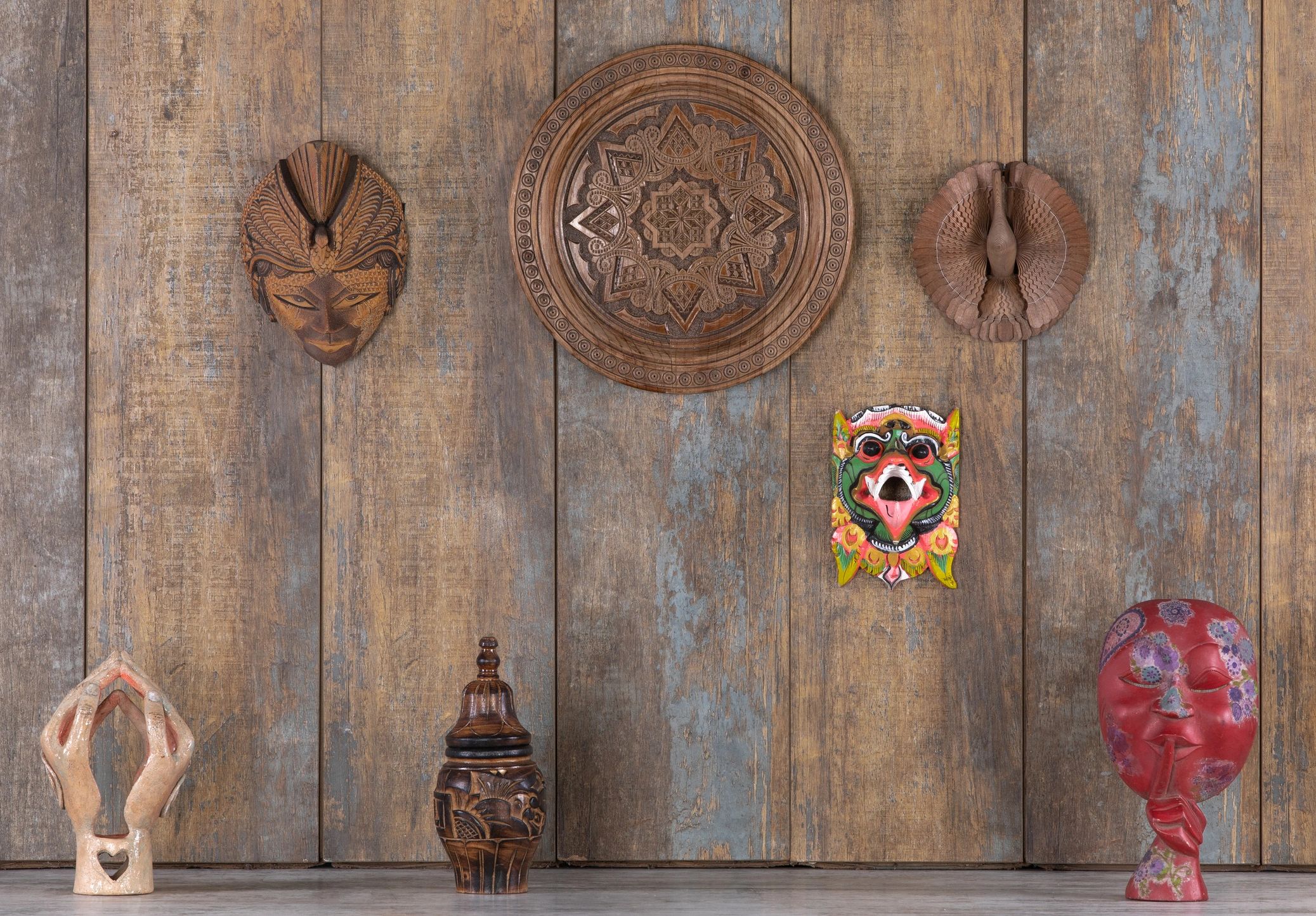 tiki culture Polynesian decor carved masks leafy greens