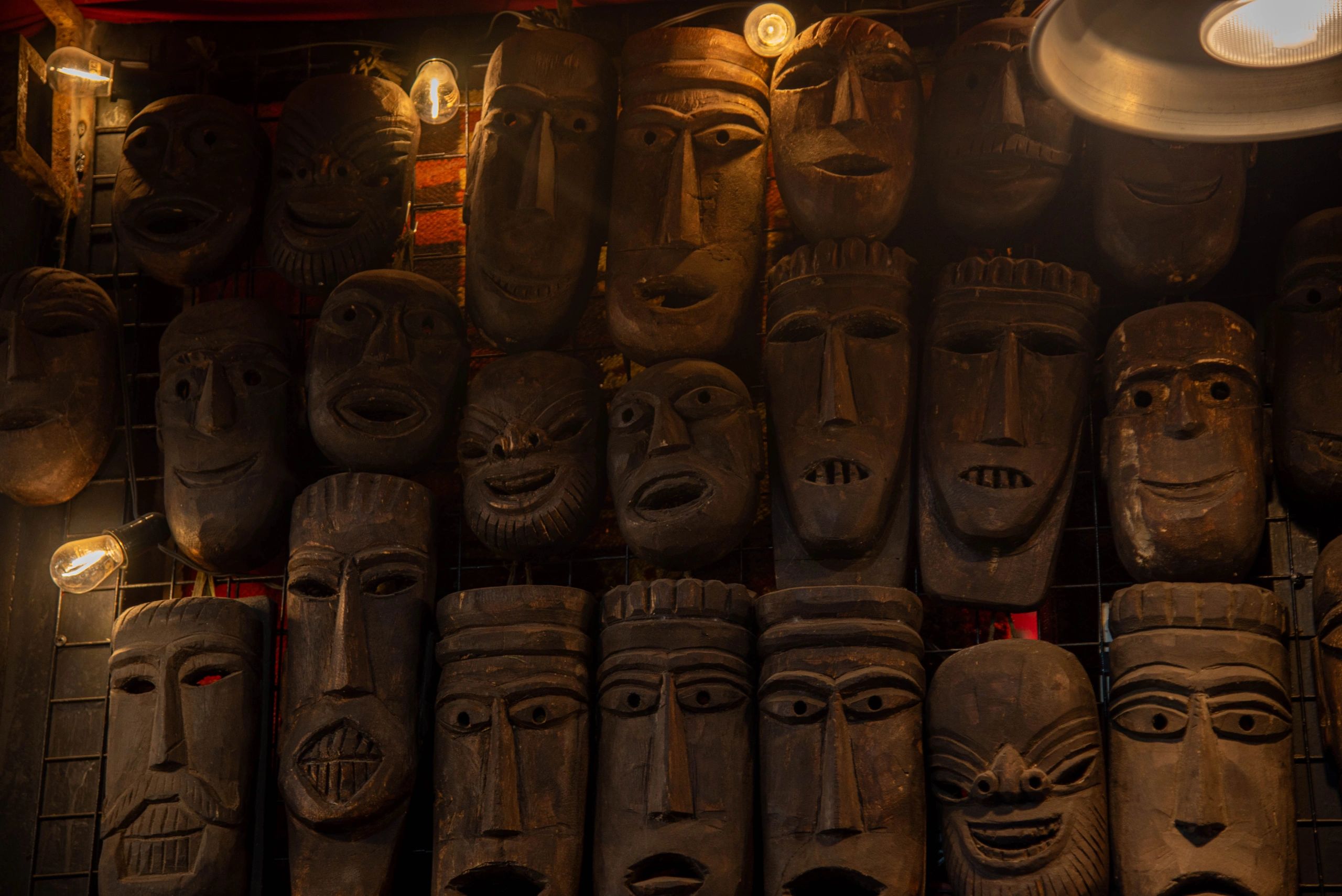 tiki culture Polynesian decor carved masks leafy greens